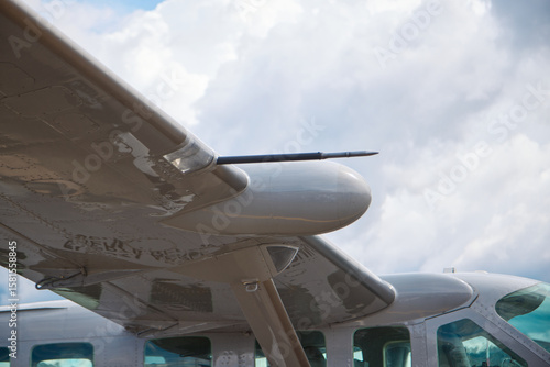Close-Up of Aircraft Wing with Pitot Tube and Cloudy Sky