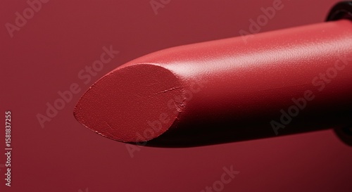 Close Up of Red Lipstick Bullet with Matte Finish on Smooth Surface