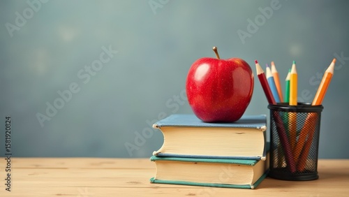 Classic Education Symbols: Apple and Books on Teacher's Desk
