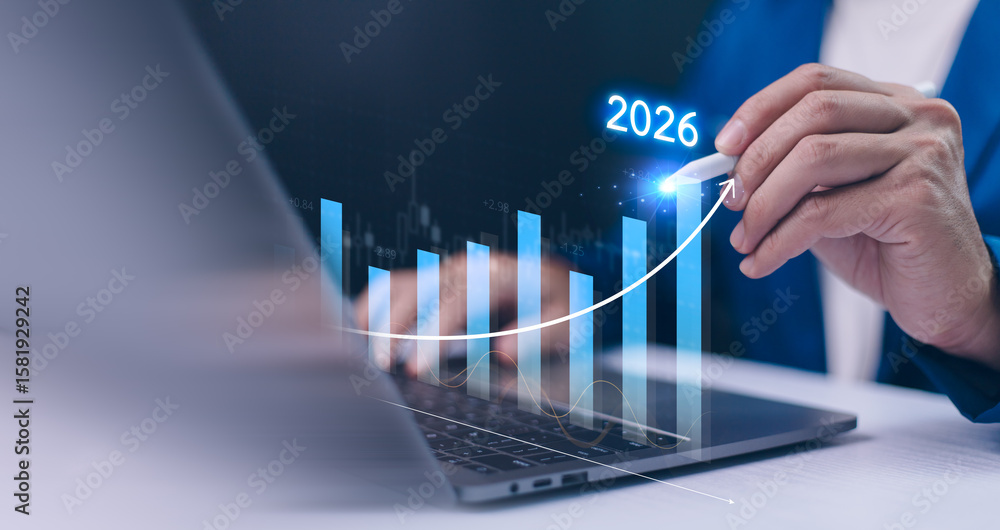 Φωτογραφία Businessman uses a stylus to draw a holographic growth arrow a bar chart on a laptop, forecasting business success and financial targets for the year 2025 to 2026