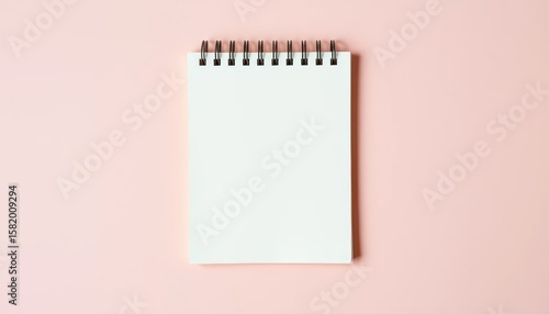 Blank notepad on pink background, perfect for writing or sketching, top view