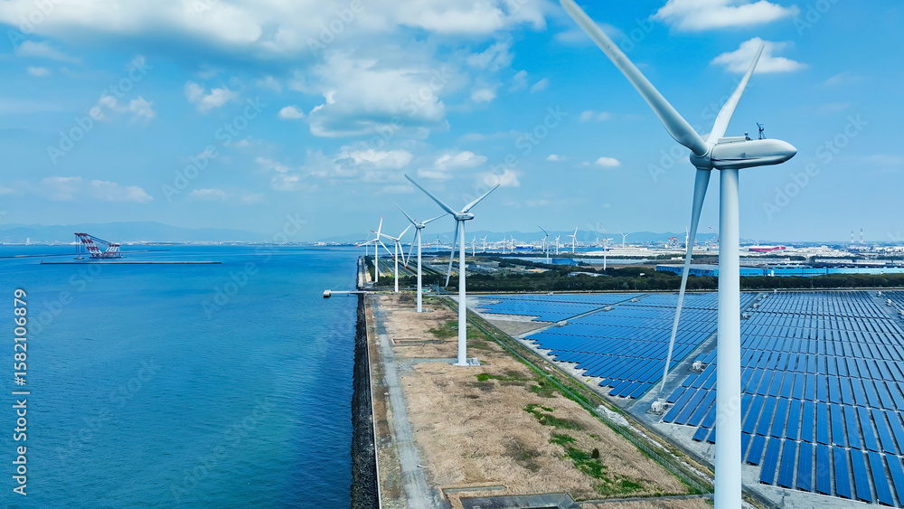 Fototapeta premium wind power generation, solar power generation, solar panel, windmills, sdgs, sustainability, renewable energy, mega solar, blue sky, hybrid, electricity, industry, infrastructure, energy, coast, scene