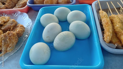 Salted duck eggs with a firm texture and savory taste, traditionally preserved in brine. A popular Asian delicacy often enjoyed with rice or porridge.