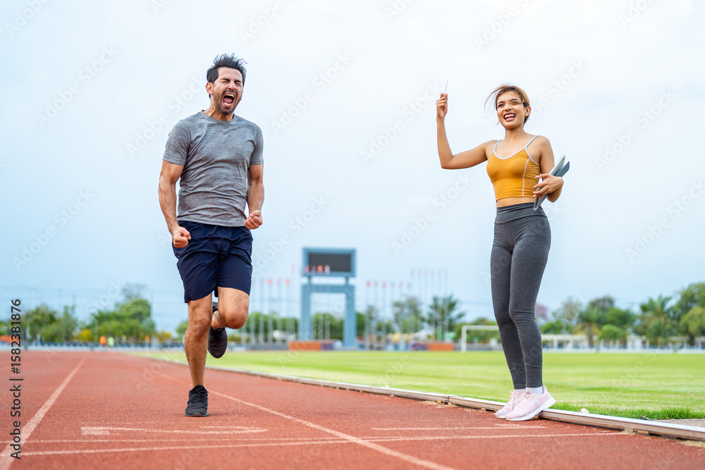 Fototapeta premium Caucasian young man athlete exercise with female trainer at the stadium. 