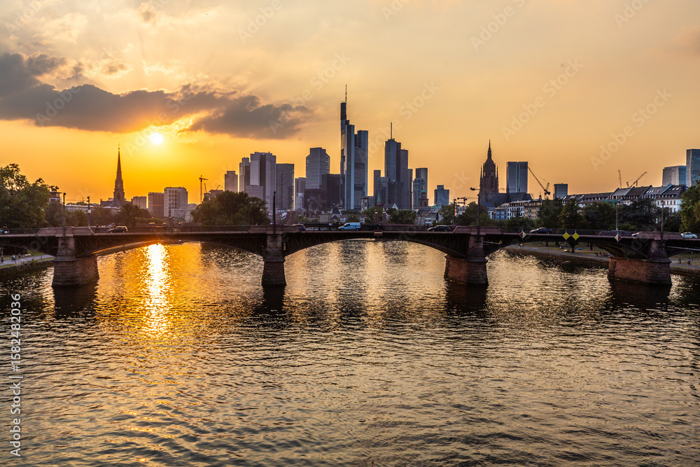 Fototapeta premium sunset at skyline of Frankfurt with river Main