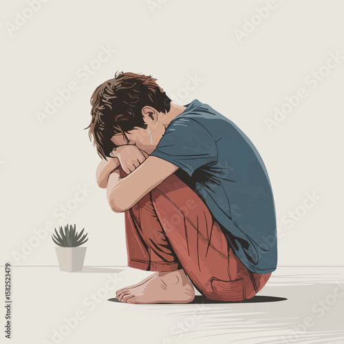 Young person sitting alone in a room with head down in despair