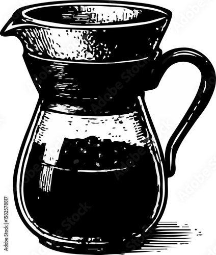 Brewed coffee inside a clear pour-over dripper with a handle, showcasing a minimalist coffee preparation
