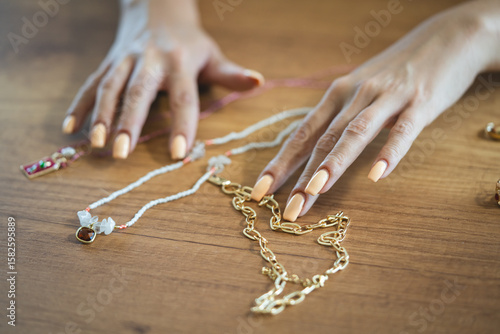female hands hold handmade necklace, summer accessorize