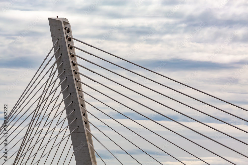 Modern cable-stayed bridge architecture against clouded sky showcasing contemporary engineering design Modern cable-stayed bridge architecture against clouded sky showcasing contemporary engineering design