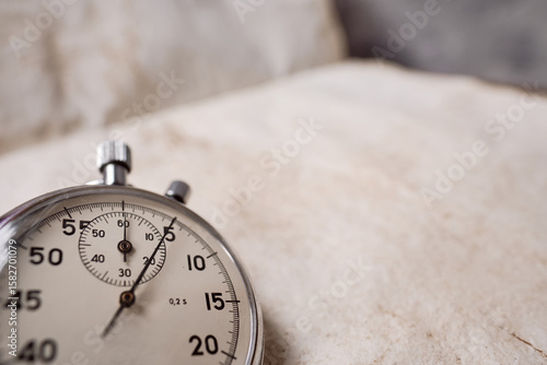 Mechanical stopwatch copy space, Clock time stop watch ticking on a 5 seconds. Half of Clock dial close-up isolated.  vintage textured paper background