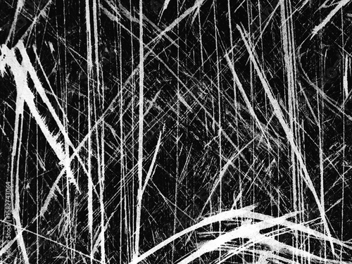 Abstract black and white texture with scratched lines on a dark surface