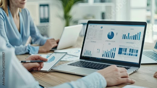 Team collaborates on analysis of performance metrics and data visualizations to improve business strategies and outcomes