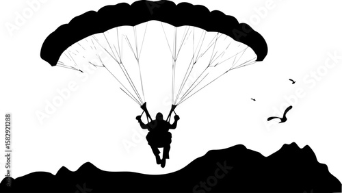Silhouette of a paraglider descending over a mountainous landscape with birds flying in the sky above it
