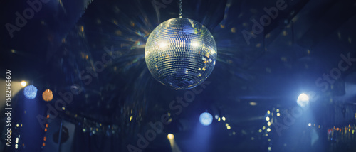 A sparkling disco ball reflects colorful lights, creating a vibrant party atmosphere full of energy, dance, and celebration.