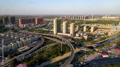 Traffic flow and infrastructure on Shijiazhuang Northeast Second Ring Road overpass during daylight