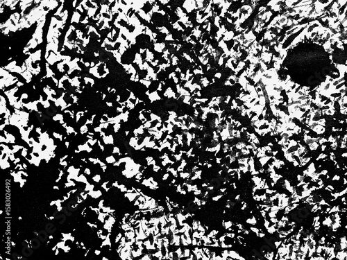 Abstract black and white texture created by bold brush strokes depicting layered patterns and movement in an artistic composition