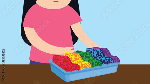 Girl with a box of colorful plasticine