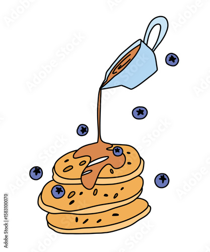 Syrup pouring from a gravy boat onto a stack of baked pancakes surrounded by blueberries