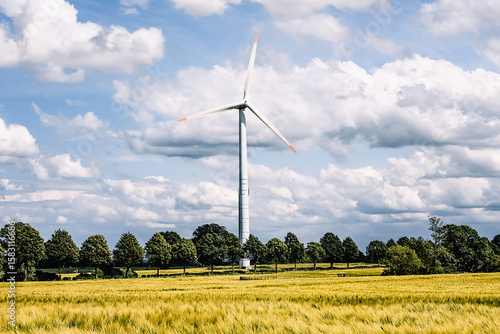A wind turbine for generating electricity on a meadow in Germany.