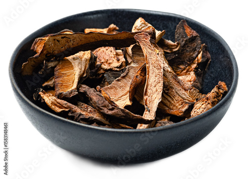 Organic dried forest mushrooms mix chantere porcini gourmet wild fungi in black bowl on transparent background