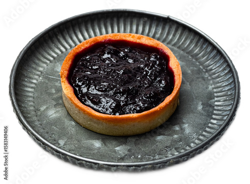 Mini berry jam tart with rustic shortcrust pastry shell on a textured silver plate, vibrant dark berry filling, inviting dessert with a rustic charm, isolated on transparent background