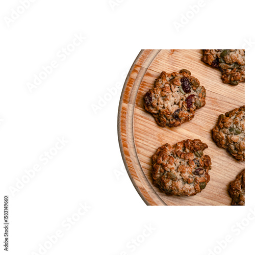Homemade oatmeal cookies with nuts and dried fruits on a round wooden tray, isolated on transparent background, warm tones, textured surface, appetizing, fresh, baked, delicious, crunchy, wholesome