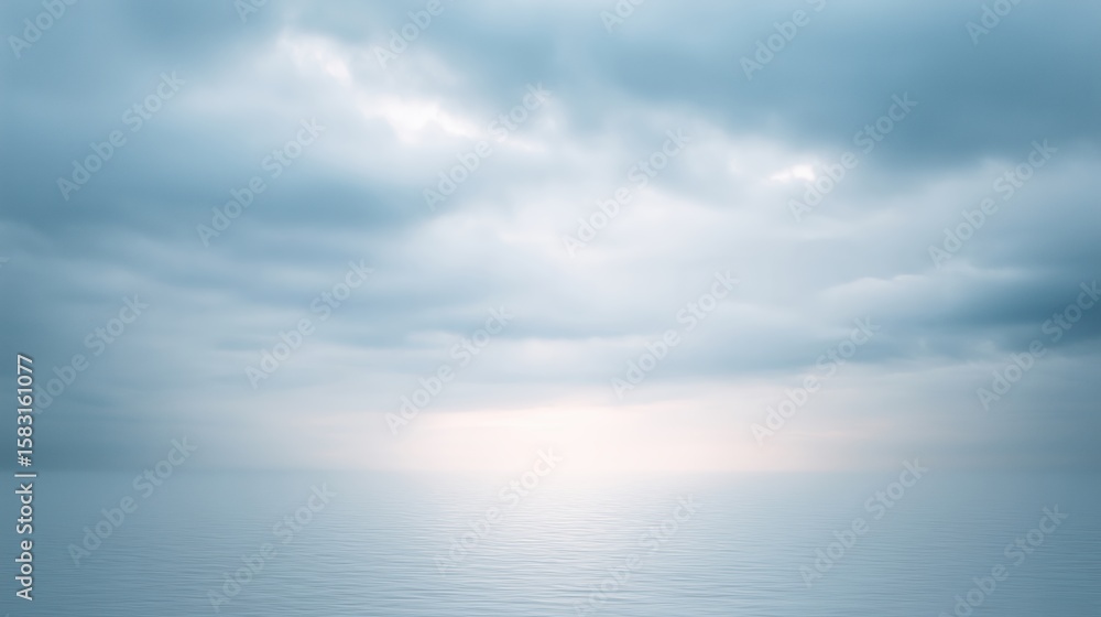 Obraz premium Serene seascape with calm water reflecting soft blue hues of overcast sky, creating a tranquil atmosphere with gentle waves and distant horizon, evoking peace and serenity