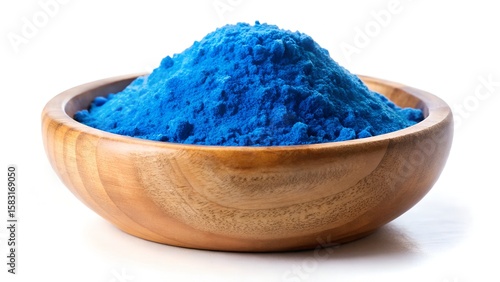 Bright blue spirulina powder pile in wooden bowl isolated on white