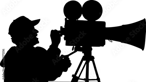 Silhouette of a filmmaker operating an old fashioned camera with a megaphone attachment on a tripod stand