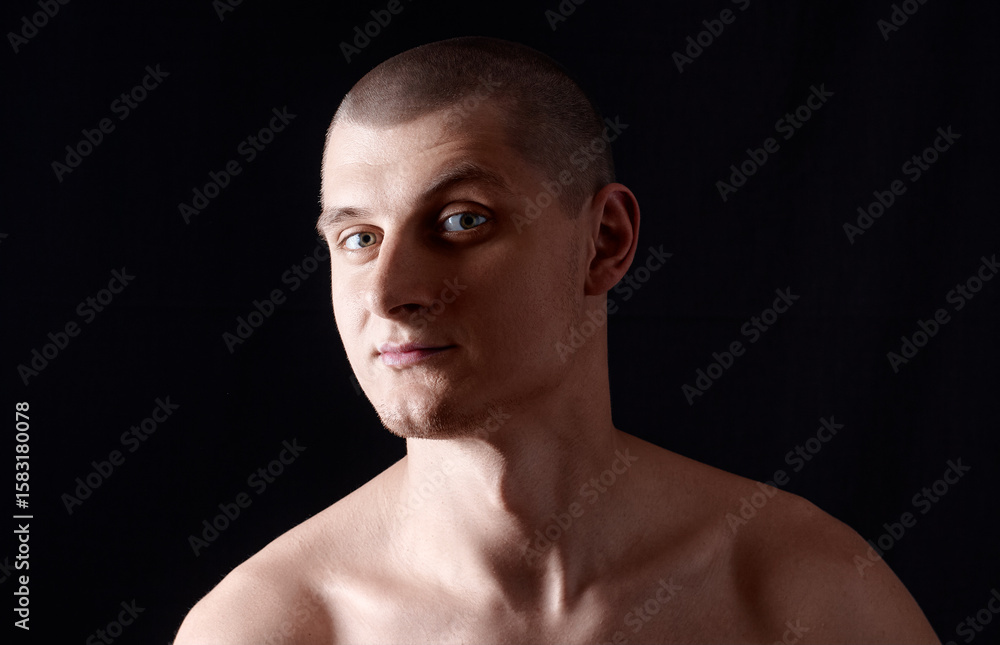 Portrait of a Young Man Against a Black Studio Background Portrait of a Young Man Against a Black Studio Background
