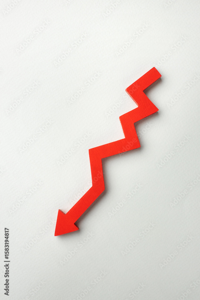 A red downward zigzag arrow on a light gray background, symbolizing a decline in business, finance, or market trends. High quality photo A red downward zigzag arrow on a light gray background, symbolizing a decline in business, finance, or market trends. High quality photo