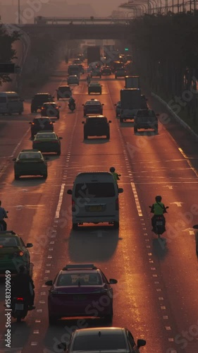Cars traffic on a busy multi-lane road at morning. Vertical video 4k