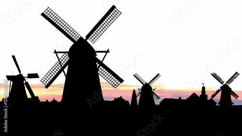 Silhouette of windmills and buildings against a colorful sunset sky in a rural landscape scene