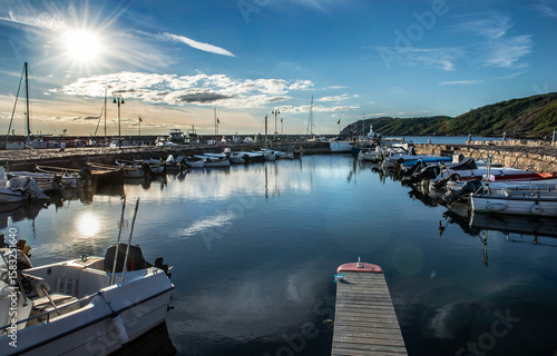 boats moored in the port of a small swedish seaside town Molle at sunset