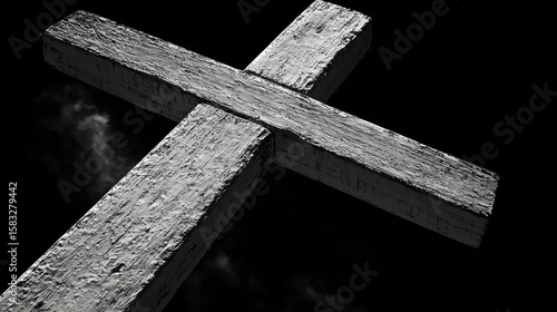 Close-up of a wooden cross against a dark background.