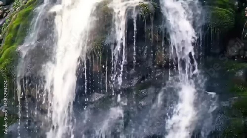 Wallpaper Mural Serene waterfall cascading over moss-covered rocks, creating a refreshing and peaceful atmosphere Torontodigital.ca