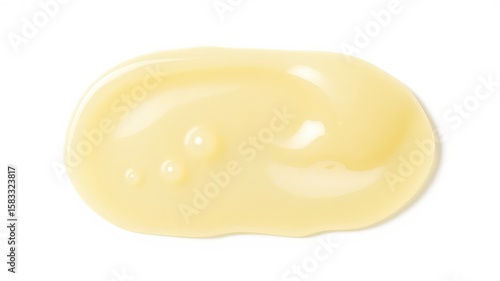 Yellow smooth cosmetic cream with small droplets and glossy texture is isolated on a clean white background