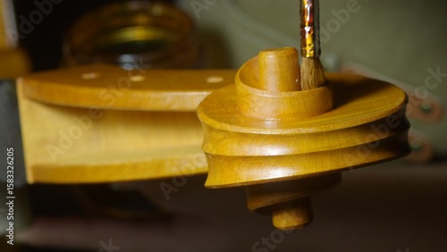 Obraz na plátně Skilled luthier brushing varnish onto delicate cello scroll, highlighting meticu