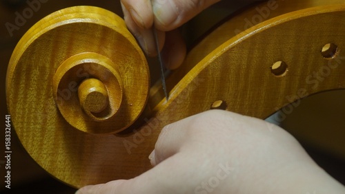 Obraz na plátně Skilled luthier carving intricate cello scroll with specialized woodworking tool