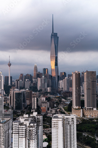 Futuristic skyscraper dominating Kuala Lumpur skyline at dusk, Malaysia