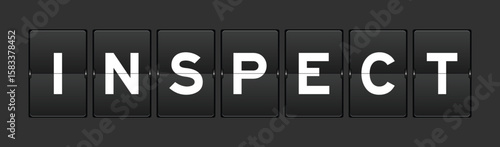 Black color analog flip board with word inspect on gray background