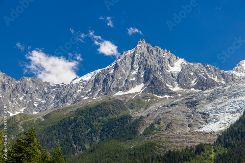 Chamonix valley landscape of a prominent rocky towering mountain peak Aiguille du Midi in French Alps. Chamonix-Montblanc area, Tour du Montblanc beautiful landscape Aiguille du Midi summit, France