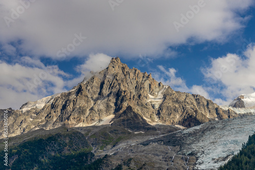 Chamonix valley landscape of a prominent rocky towering mountain peak Aiguille du Midi in French Alps. Chamonix-Montblanc area, Tour du Montblanc beautiful landscape Aiguille du Midi summit, France