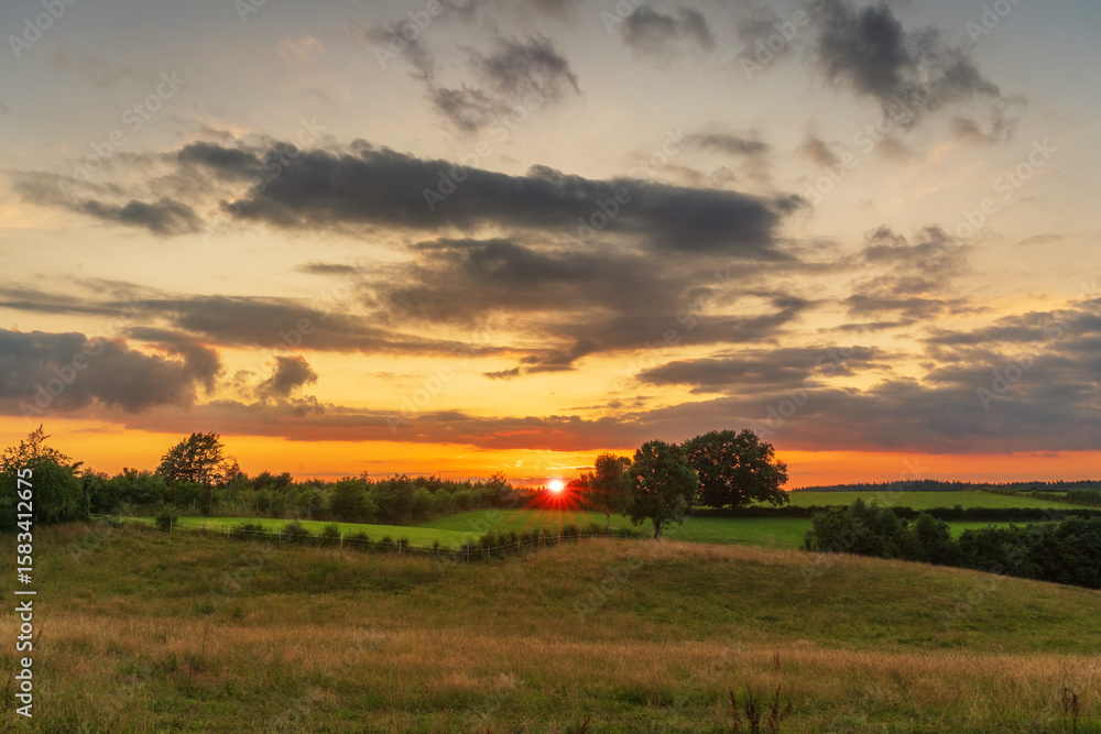 Fototapeta premium Beautiful sunset over agricultural field