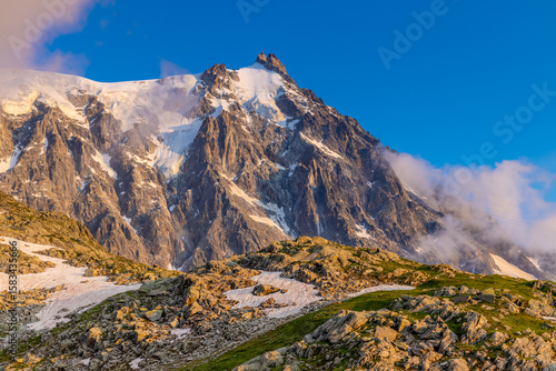 Fotografi Chamonix valley landscape of a prominent rocky towering mountain peak Aiguille du Midi in French Alps