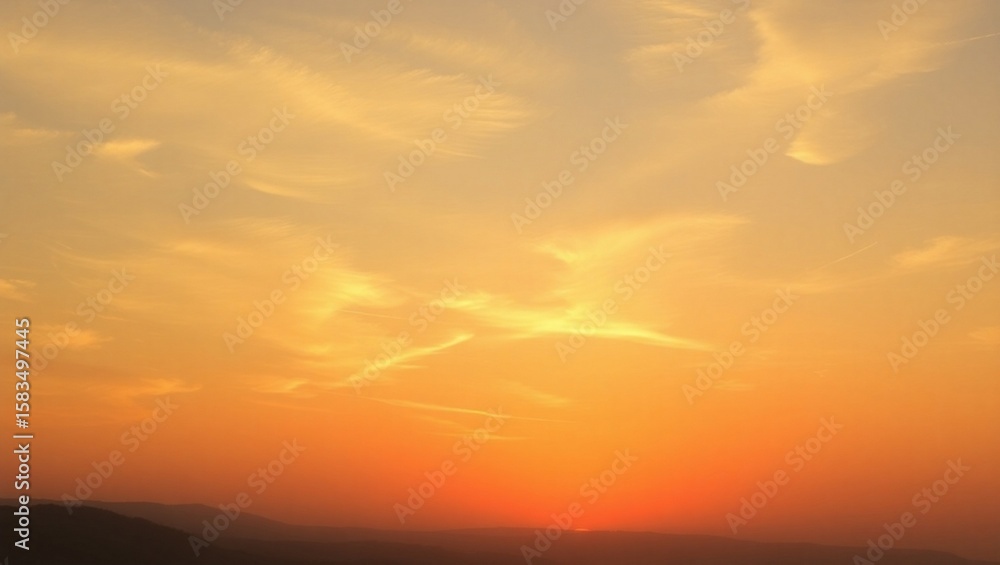 Obraz premium Beautiful Orange Sky at Sunset With Wispy Clouds