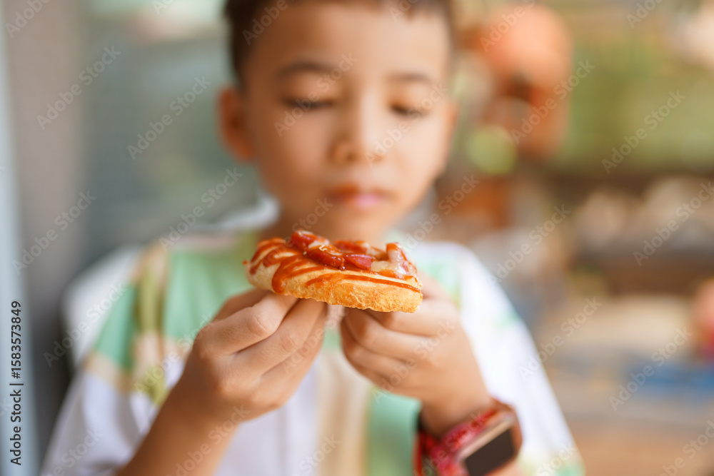Boy happily eating a sandwich during lunch meal Boy happily eating a sandwich during lunch meal