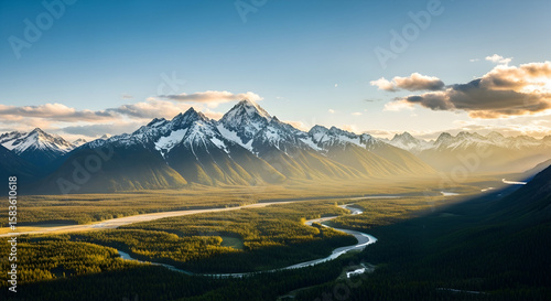 Majestic snow-capped peaks overlook a winding river through a sunlit evergreen forest at dusk