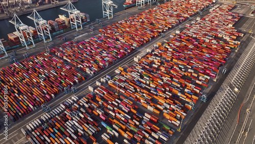 Port of Oakland, United States - 07 April 2025: Aerial view of countless shipping containers creating a vibrant mosaic of colors, stretching across the port's vast expanse.
