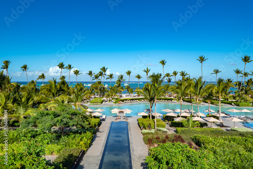 Tableau sur toile Bavaro Beach, Punta Cana: A luxurious resort pool area merges seamlessly with the stunning Caribbean beach and palm trees